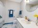 Fresh bathroom with blue and white accents, shower with curtain, and classic vanity at 1834 Dewitt Smith Rd, Pittsboro, NC 27312