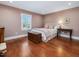 Bedroom with hardwood floors, neutral walls, and plenty of natural light from the window at 1834 Dewitt Smith Rd, Pittsboro, NC 27312