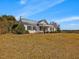 Charming white brick home with black shutters, a metal roof, and a manicured lawn at 1834 Dewitt Smith Rd, Pittsboro, NC 27312