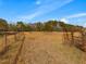 Expansive open field surrounded by mature trees, offering ample space and privacy for various outdoor activities at 1834 Dewitt Smith Rd, Pittsboro, NC 27312