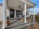 Charming front porch with slate flooring, white columns, and comfortable seating area at 1834 Dewitt Smith Rd, Pittsboro, NC 27312