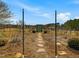 Stone path leading to a charming garden gate, inviting exploration and adding character to the property at 1834 Dewitt Smith Rd, Pittsboro, NC 27312