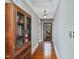 Hallway featuring hardwood floors, storage cabinet, and a view of the back yard at 1834 Dewitt Smith Rd, Pittsboro, NC 27312