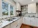 Bright kitchen featuring granite counters, stainless sink, white cabinetry and natural light at 1834 Dewitt Smith Rd, Pittsboro, NC 27312