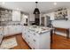 Spacious kitchen featuring a large center island, custom cabinets, and hardwood floors at 1834 Dewitt Smith Rd, Pittsboro, NC 27312