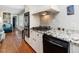 Updated kitchen featuring stainless steel appliances, granite counters, and hardwood flooring at 1834 Dewitt Smith Rd, Pittsboro, NC 27312