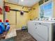 Bright laundry room with yellow walls, modern appliances, and ample storage space at 1834 Dewitt Smith Rd, Pittsboro, NC 27312