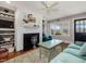 Cozy living room with fireplace, built-in shelving, and large windows offering natural light at 1834 Dewitt Smith Rd, Pittsboro, NC 27312