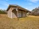 Exterior view of an outbuilding featuring traditional architecture and covered porch at 1834 Dewitt Smith Rd, Pittsboro, NC 27312