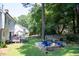 Backyard featuring a deck, a firepit, and a well-maintained lawn surrounded by trees at 2006 Chedington Dr, Apex, NC 27502