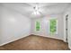 Neutral bedroom featuring a ceiling fan, and two windows at 2006 Chedington Dr, Apex, NC 27502