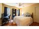 Comfortable bedroom featuring wood floors, a ceiling fan, and a well-lit desk area at 2006 Chedington Dr, Apex, NC 27502