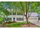 Charming two-story home with a lush lawn, two-car garage, and a bright blue front door at 2006 Chedington Dr, Apex, NC 27502