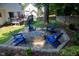 Backyard firepit area surrounded by adirondack chairs and lush landscaping at 2006 Chedington Dr, Apex, NC 27502