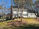 Traditional two-story home boasting white siding, black shutters, attached two-car garage, and landscaped front yard at 2006 Chedington Dr, Apex, NC 27502