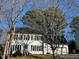 Traditional two-story home boasting white siding, black shutters, attached two-car garage, and landscaped front yard at 2006 Chedington Dr, Apex, NC 27502