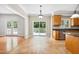 Eat-in kitchen featuring stainless steel appliances, granite countertops, and access to the back deck at 2006 Chedington Dr, Apex, NC 27502