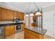 Kitchen with stainless steel appliances, granite counters, wood cabinets, and an island at 2006 Chedington Dr, Apex, NC 27502