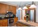 Well-equipped kitchen featuring stainless steel appliances, granite countertops, wooden cabinets, and a center island at 2006 Chedington Dr, Apex, NC 27502