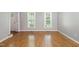 Bright living room with hardwood floors, natural light, and neutral wall color at 2006 Chedington Dr, Apex, NC 27502