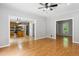 Open-concept living room with views of the kitchen, featuring hardwood floors and neutral wall colors at 2006 Chedington Dr, Apex, NC 27502