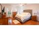 Bright and airy main bedroom boasting hardwood floors, neutral decor, and ample natural light from the windows at 2006 Chedington Dr, Apex, NC 27502