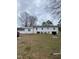 Rear exterior of the home showcasing the back yard and basement access at 2009 Windy Hill Farm Ln, Zebulon, NC 27597