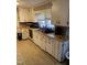 Traditional kitchen featuring white cabinetry, neutral countertops, and a stainless steel sink at 2009 Windy Hill Farm Ln, Zebulon, NC 27597