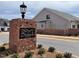 Brick community sign with a black 'Bentwinds Bluffs' sign with new homes in background at 2300 Eagle Shot Ct # 25, Fuquay Varina, NC 27526