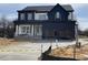 Two-story home showcasing a modern exterior design with a spacious two car garage and concrete driveway at 2300 Eagle Shot Ct # 25, Fuquay Varina, NC 27526