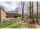 Spacious backyard featuring a grassy lawn and mature trees bordering the property at 2504 Churchill Dr, Burlington, NC 27215