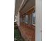 Brick front porch featuring brick flooring, columns, blue shutters, and brick exterior at 2504 Churchill Dr, Burlington, NC 27215