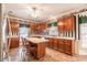 Bright eat-in kitchen with wood cabinets, neutral countertops, and tile floors at 2504 Churchill Dr, Burlington, NC 27215