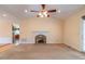 Bright living room featuring a fireplace, neutral carpet, and large windows at 2504 Churchill Dr, Burlington, NC 27215