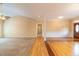 Open-concept living space with carpet and hardwood floors and a charming front door at 2504 Churchill Dr, Burlington, NC 27215