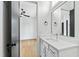 Bright bathroom featuring a white vanity with quartz countertop, black hardware, and a view into the bedroom at 2728 Milburnie Rd, Raleigh, NC 27610
