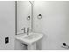 This powder room is well lit and features a pedestal sink with modern fixtures at 2728 Milburnie Rd, Raleigh, NC 27610