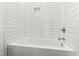 Clean, modern bathtub with white subway tile surround, chrome fixtures, and built-in shower niche at 2728 Milburnie Rd, Raleigh, NC 27610