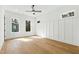 Bright bedroom with wood floors, board and batten accent wall, and large windows at 2728 Milburnie Rd, Raleigh, NC 27610