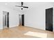Spacious bedroom with wood flooring and contrasting black doors and ceiling fan at 2728 Milburnie Rd, Raleigh, NC 27610