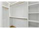Walk-in closet with wood shelving and hanging rods for storage and organization at 2728 Milburnie Rd, Raleigh, NC 27610