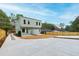 Backyard view of modern home featuring a concrete patio and privacy fence; great for entertaining at 2728 Milburnie Rd, Raleigh, NC 27610