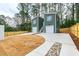 Exterior view of charming two-unit home featuring garage, stairs to the apartments, and modern design at 2728 Milburnie Rd, Raleigh, NC 27610