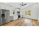 Bright, modern kitchen with white cabinets, stainless steel appliances, hardwood floors, and a ceiling fan at 2728 Milburnie Rd, Raleigh, NC 27610