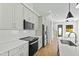 Modern kitchen featuring stainless steel appliances, quartz countertops, and white cabinetry at 2728 Milburnie Rd, Raleigh, NC 27610