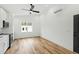 Bright, modern kitchen with white cabinets, stainless steel appliances, hardwood floors, and a ceiling fan at 2728 Milburnie Rd, Raleigh, NC 27610