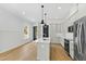 Modern kitchen with a large window, stainless steel appliances, white cabinets, and a breakfast bar at 2728 Milburnie Rd, Raleigh, NC 27610