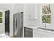 Well-lit kitchen features stainless appliances, white cabinets, and view from a window over the sink at 2728 Milburnie Rd, Raleigh, NC 27610