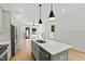 Well-lit kitchen with stainless steel appliances, quartz countertop island, and an open layout at 2728 Milburnie Rd, Raleigh, NC 27610