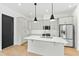 Bright kitchen features an island, stainless steel appliances, and modern light fixtures at 2728 Milburnie Rd, Raleigh, NC 27610